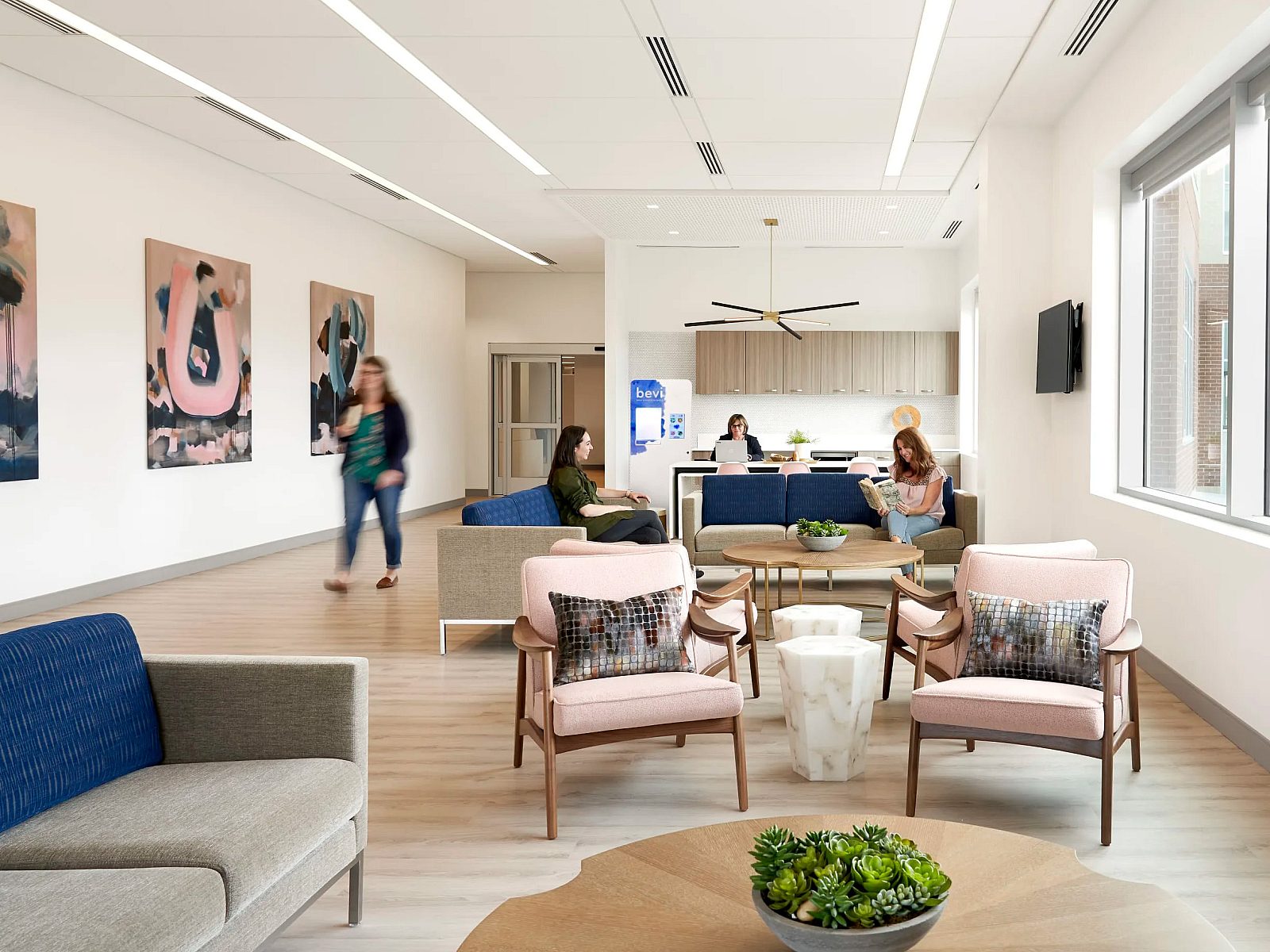 A modern hospital waiting area featuring inviting furniture in soft colors, creating a calming atmosphere for patients.