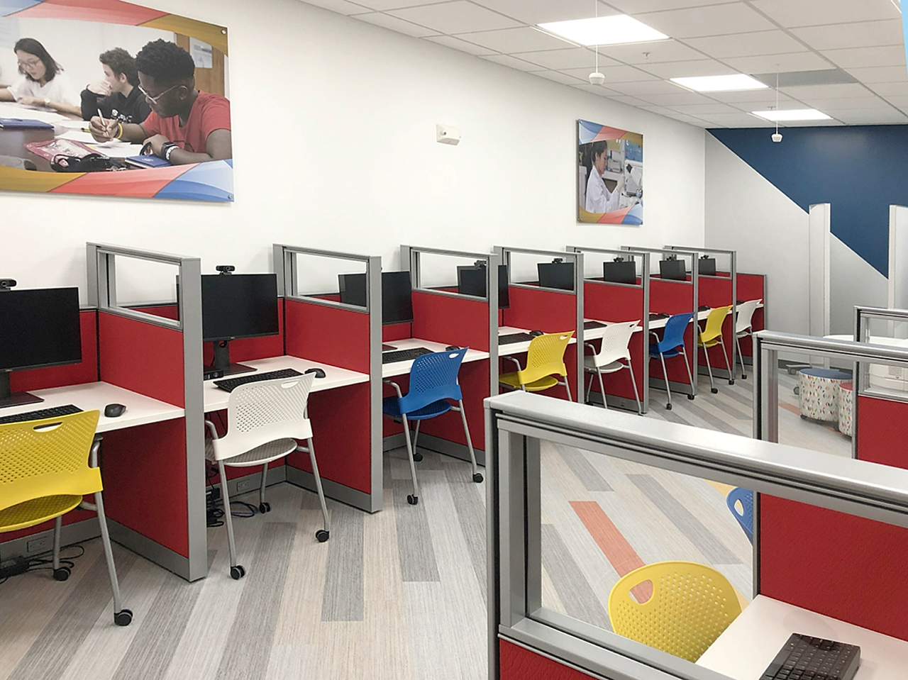 Colorful workstations in the youth room offer kids a welcoming space for homework while their grownups focus on training & job search.
